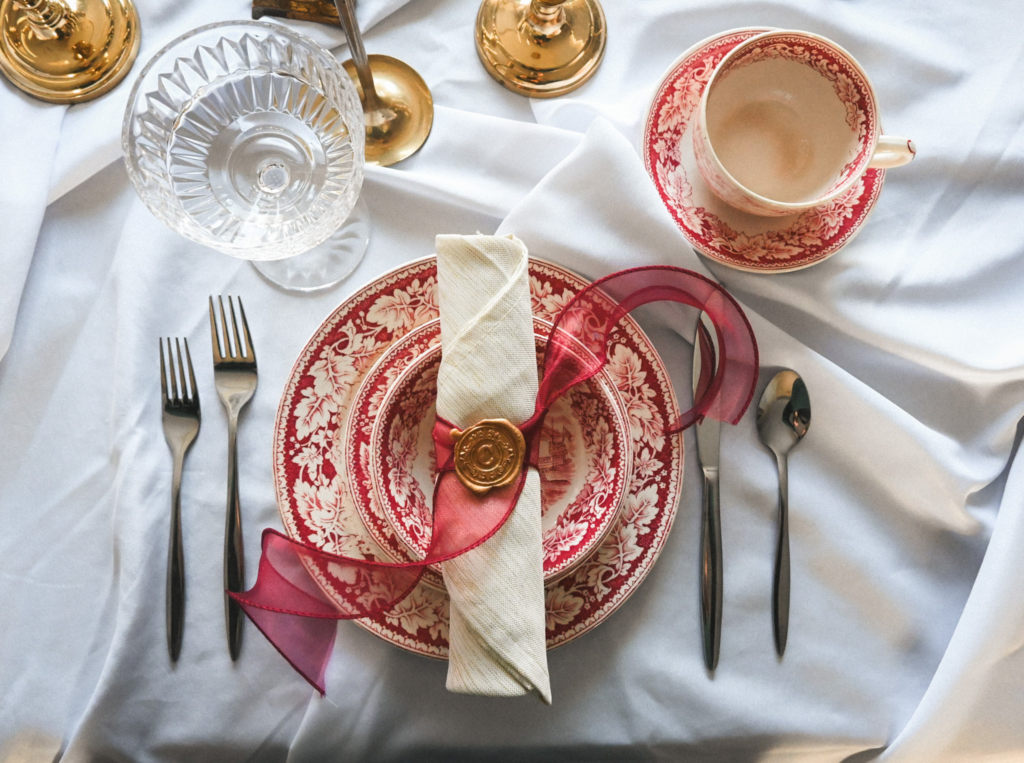 Table setting with plate, flatware, cups, and stemware