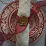 Pink and white plate with napkin on top