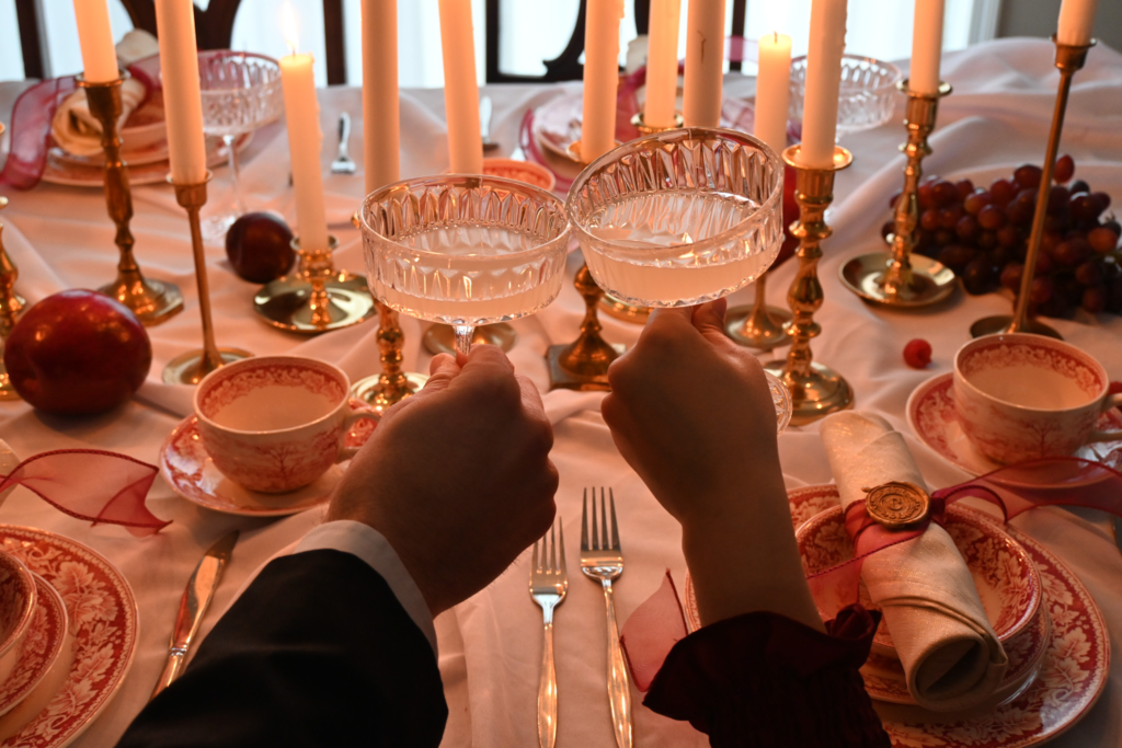 Two people holding up stemware with champagne for a toast