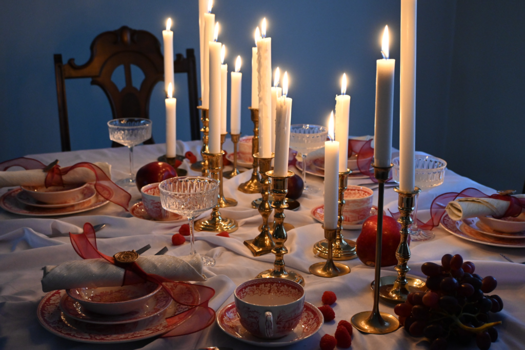 Table setting with brass candlesticks lit up