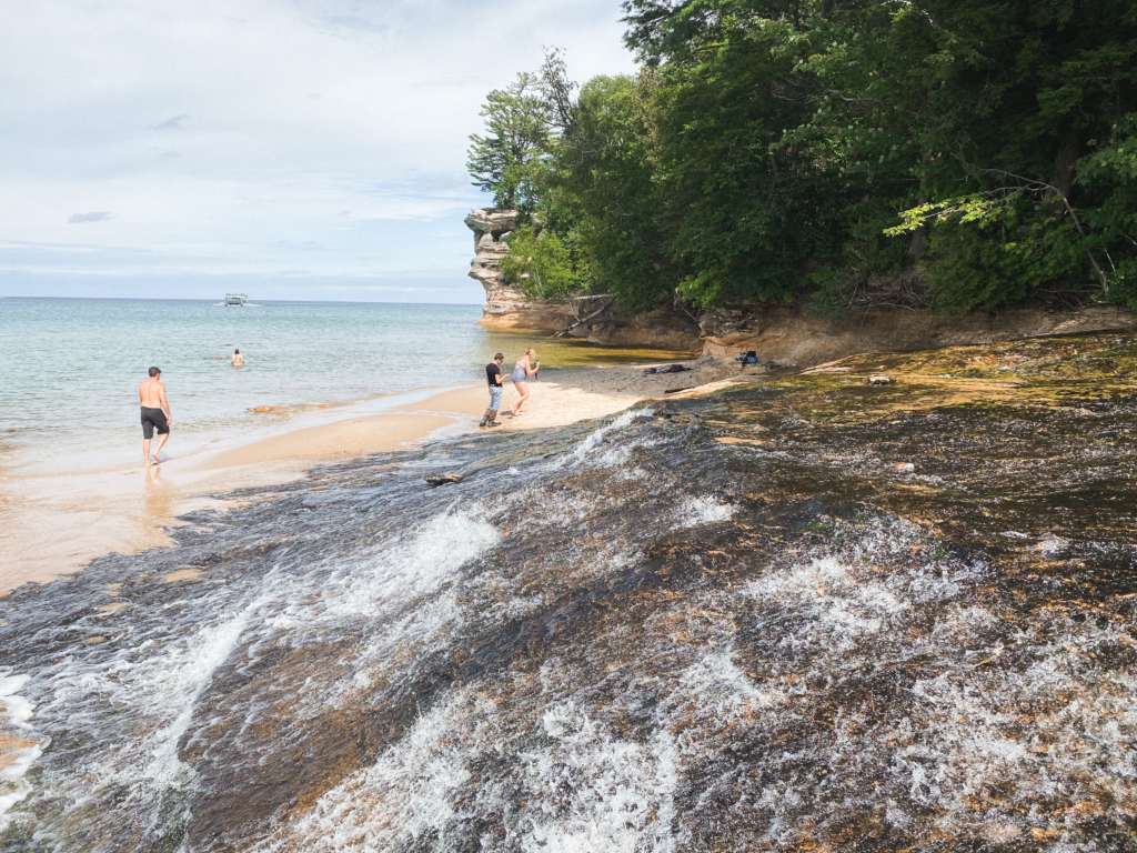 Pictured rocks national lakeshore beach with people in water