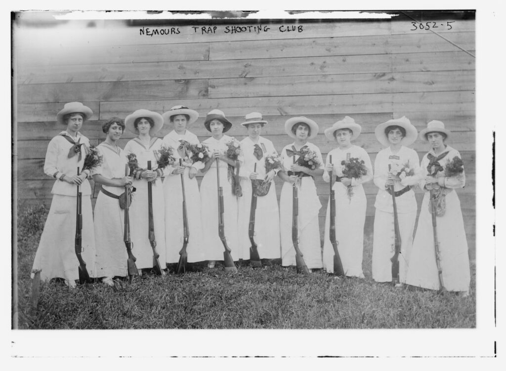 A black and white photograph of women at the Nemours Trap Shooting Club