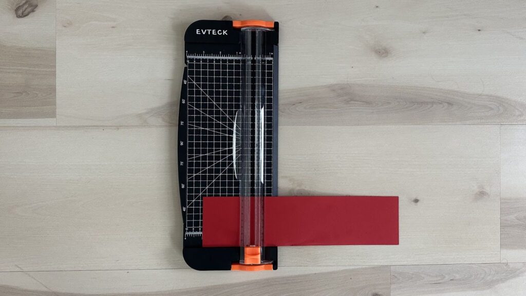 Paper cutter trimming 3x12-inch piece of paper