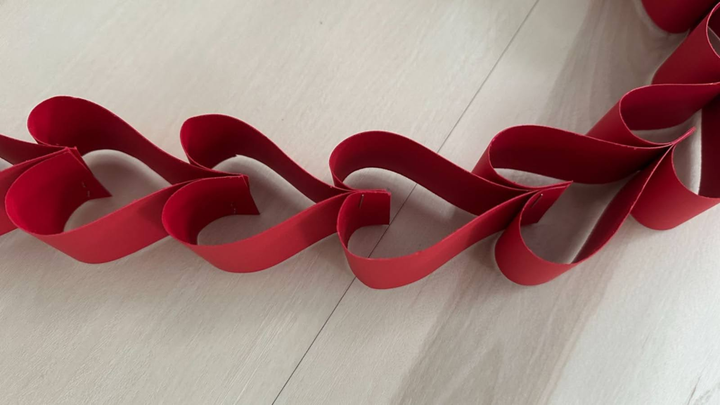Red paper heart garland on wood floor