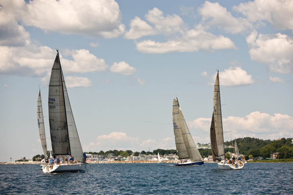 Sailboats on the water near Mackinac Island with a slightly overcast sky