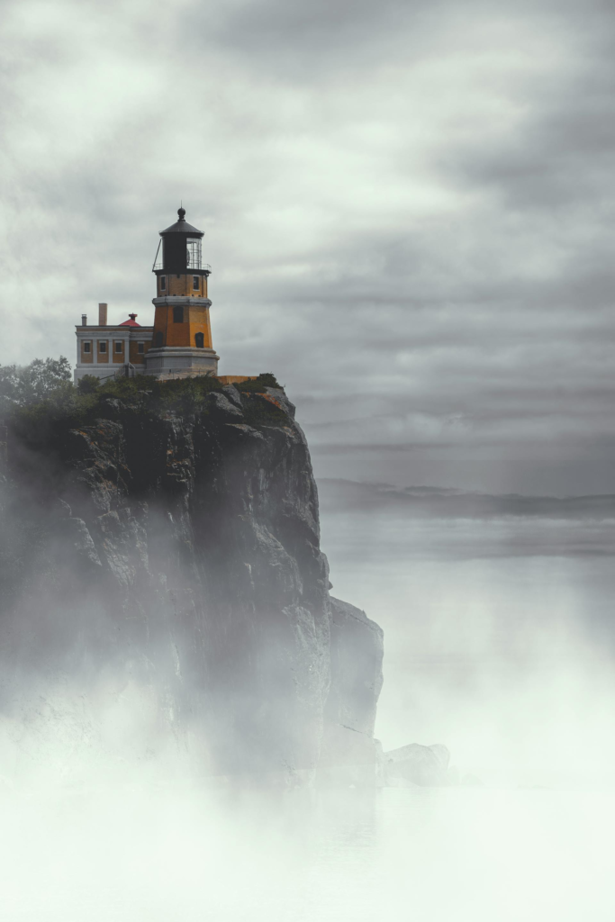 Split rock lighthouse set against dark, stormy sky