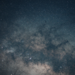 A vibrant view of the Milky Way galaxy and thousands of stars in a deep blue night sky over the Great Lakes region.