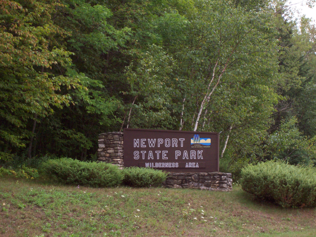 Newport State Park entrance sign set against the forest.