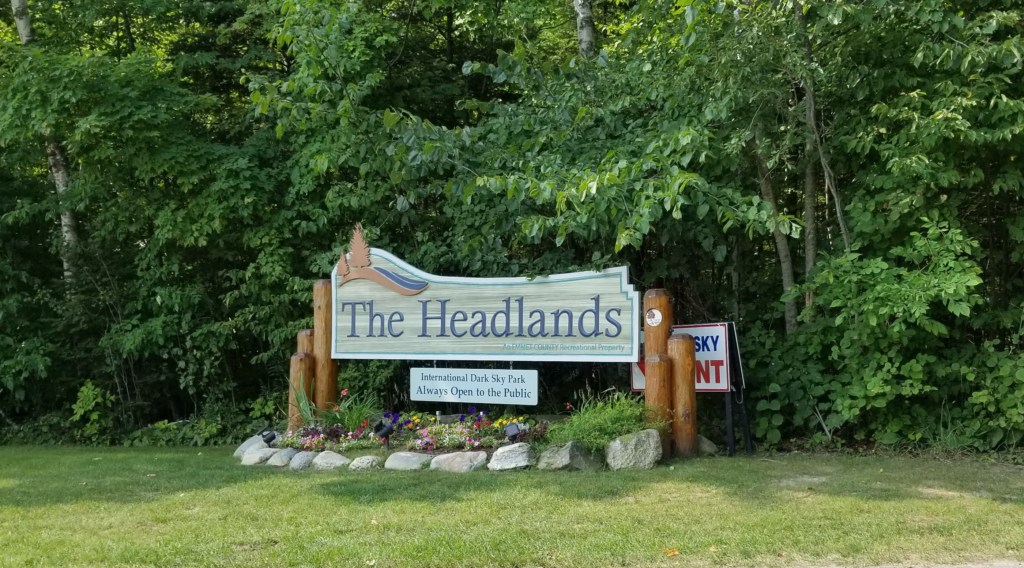 The Headlands International Dark Sky Park entrance sign set against the forest.