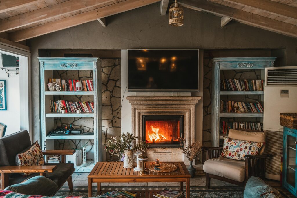 Cozy interior cabin with bookshelves, fireplace, and furniture